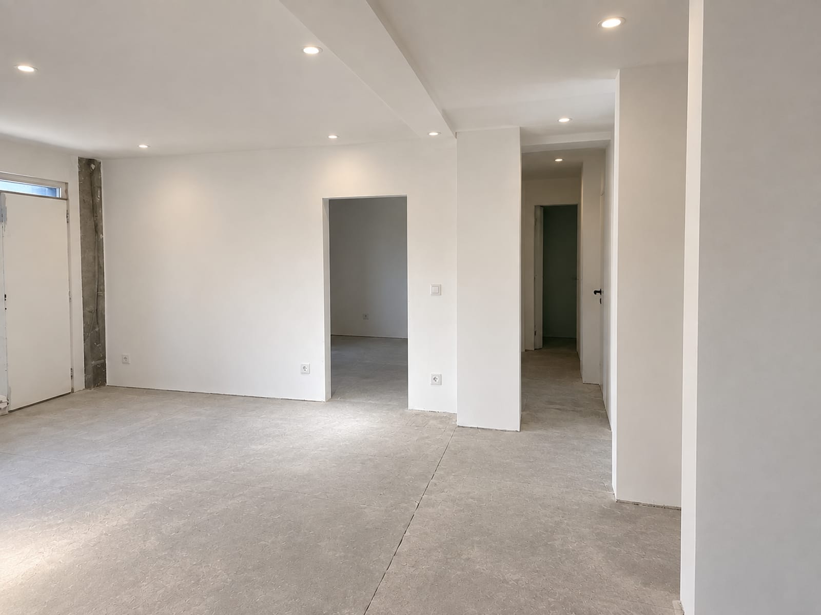 Appartement en plâtrerie terminée : murs et plafonds lisses avec spots encastrés